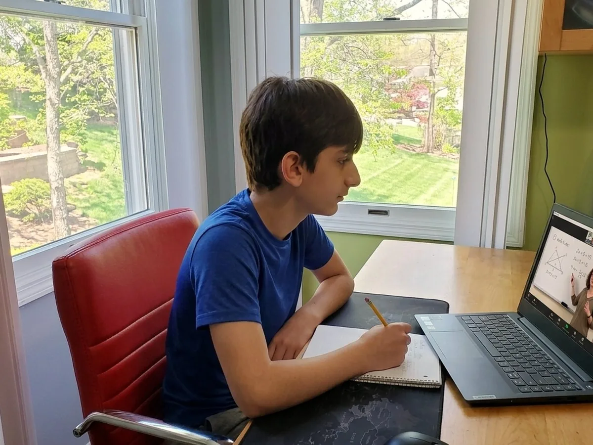 Avatar student working at her desk during an online tutoring session