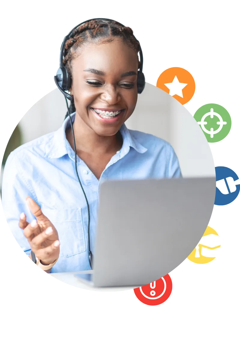 Tutor wearing a headset smiles at a laptop during an online lesson